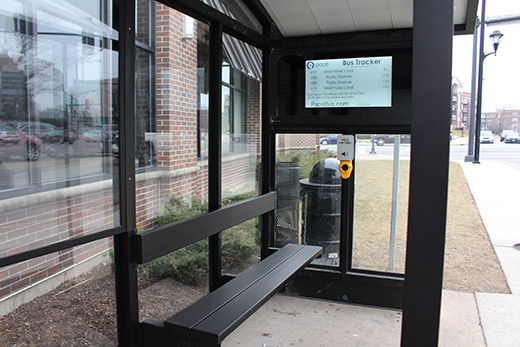 This is an image of an e-ink bus tracker sign imbedded in a Pace bus shelter.