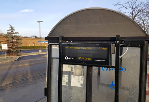 This is an image of a digital bus tracker sign installed on one of Pace's bus shelters.