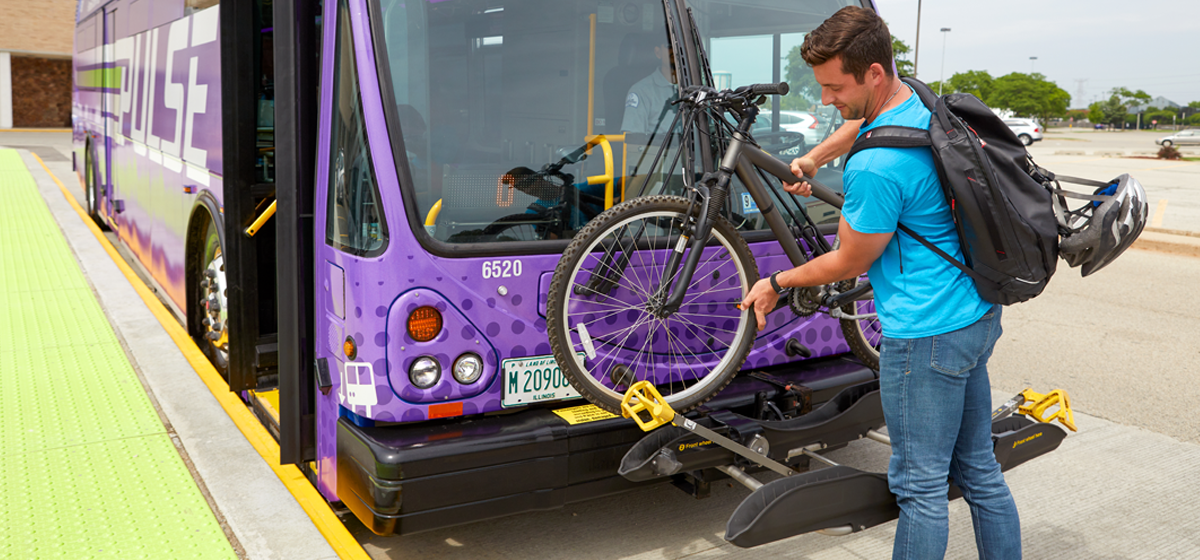 Image of Pace passenger mounting his bike on the front of the bus