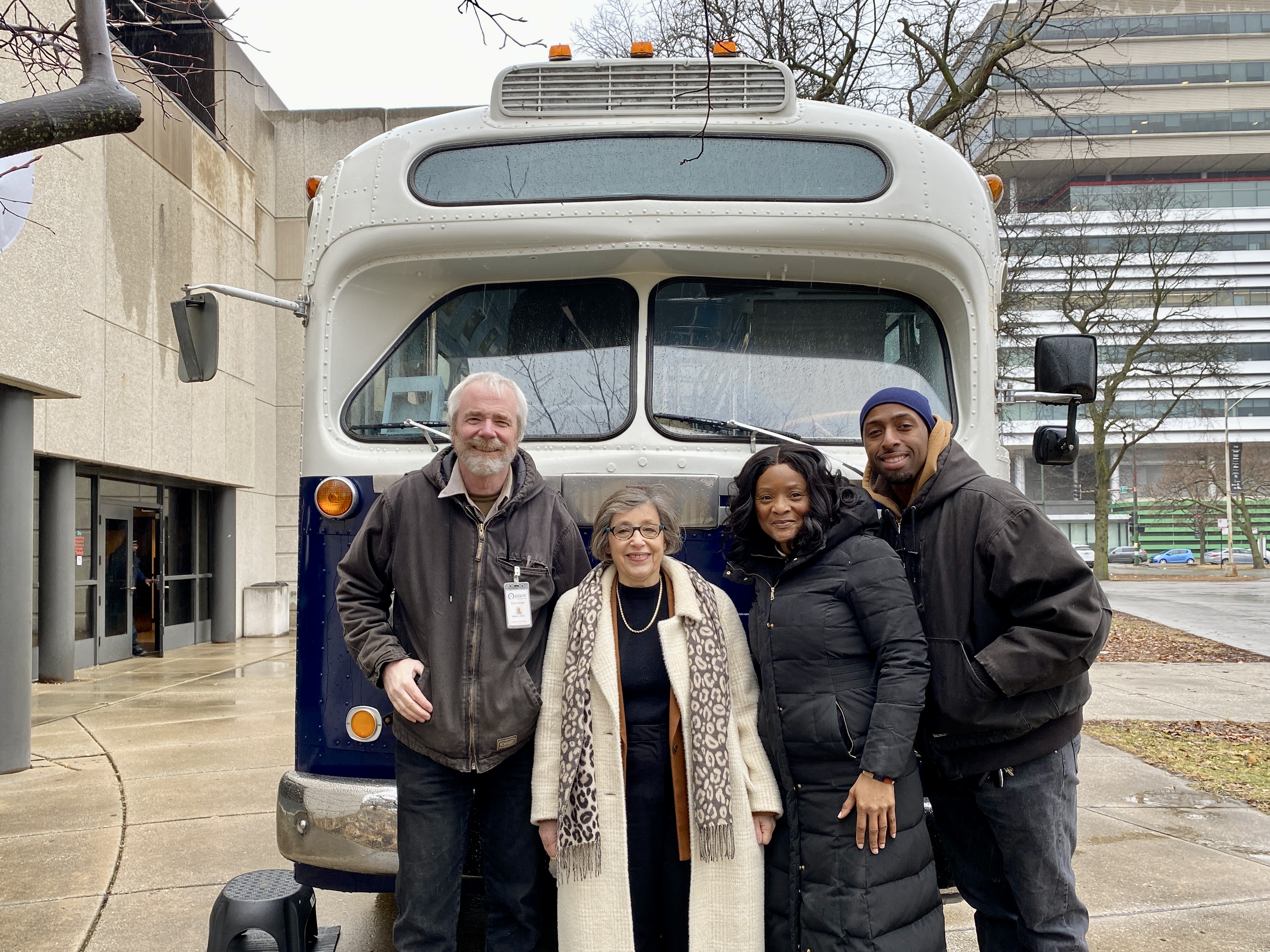 Pace staff with vintage bus outside museum