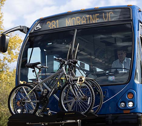 Image of a bus and driver is ready to go with bikes loaded on bike rack