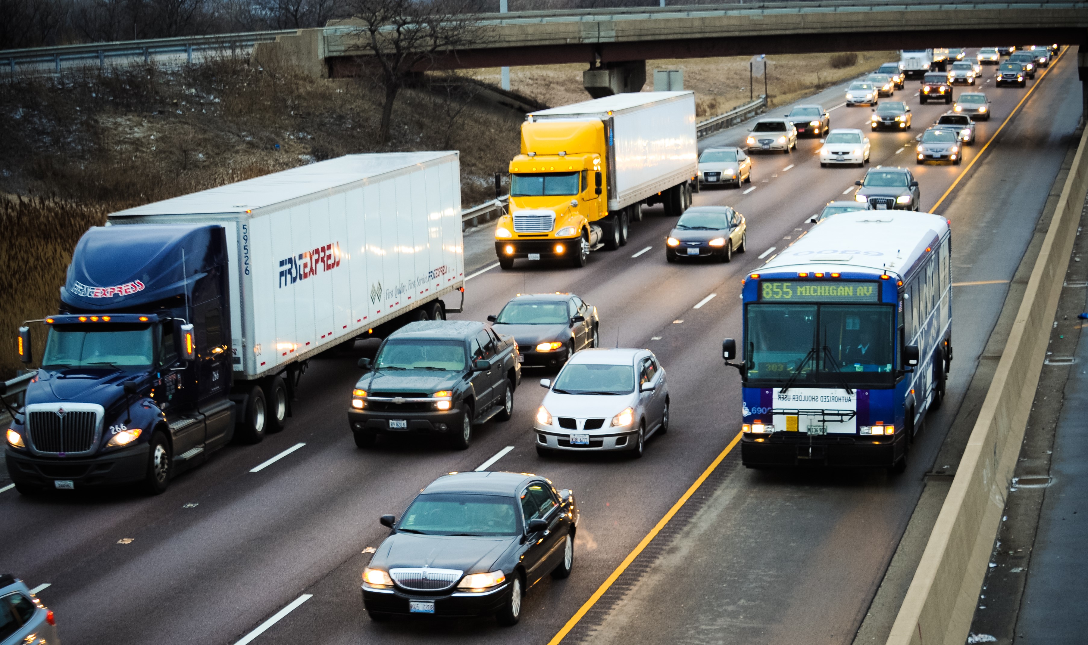 bus traveling on shoulder of expressway