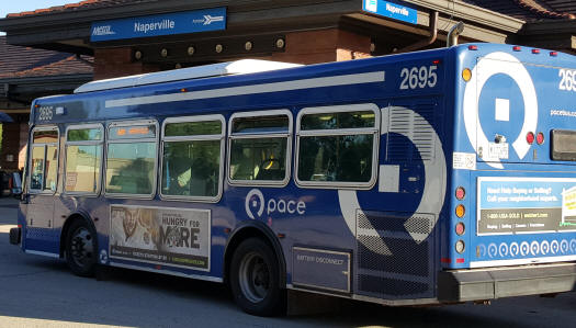 Image of a Pace bus displaying a queen size bus ad