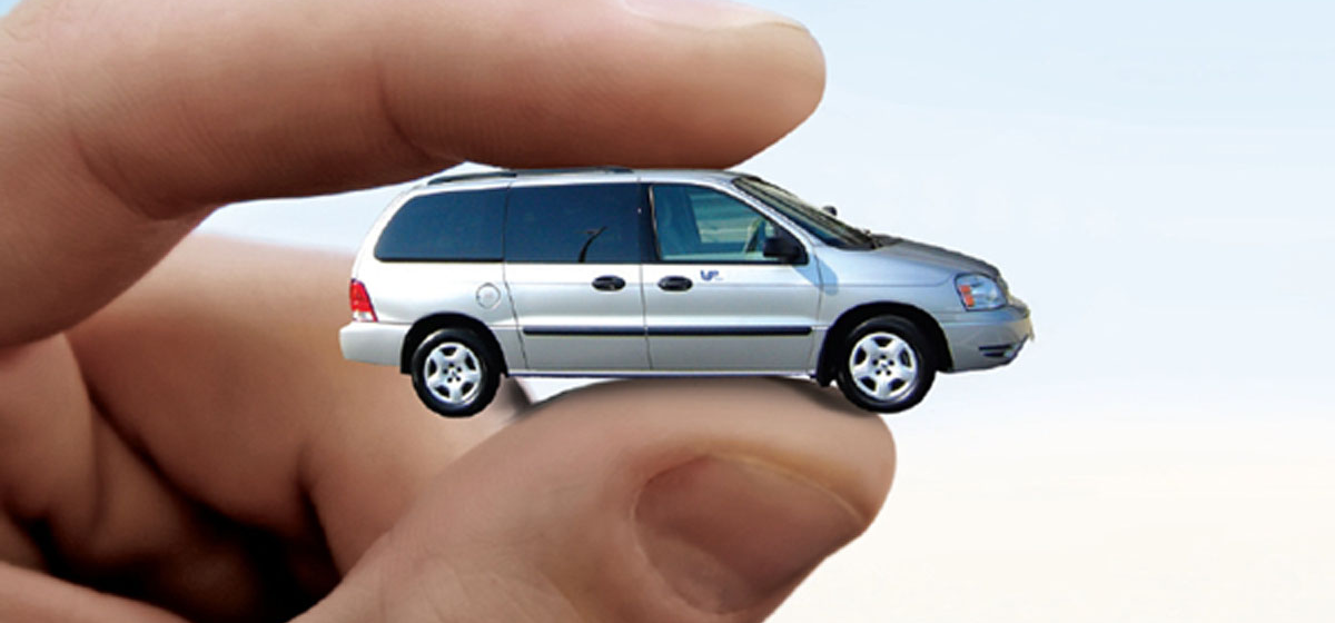 fingers holding a tiny van