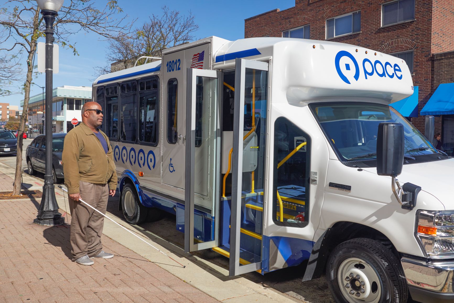 visually impaired rider boards paratransit bus