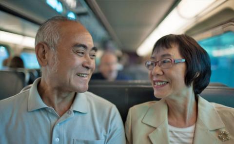 This is an image of a couple riding on transit together.