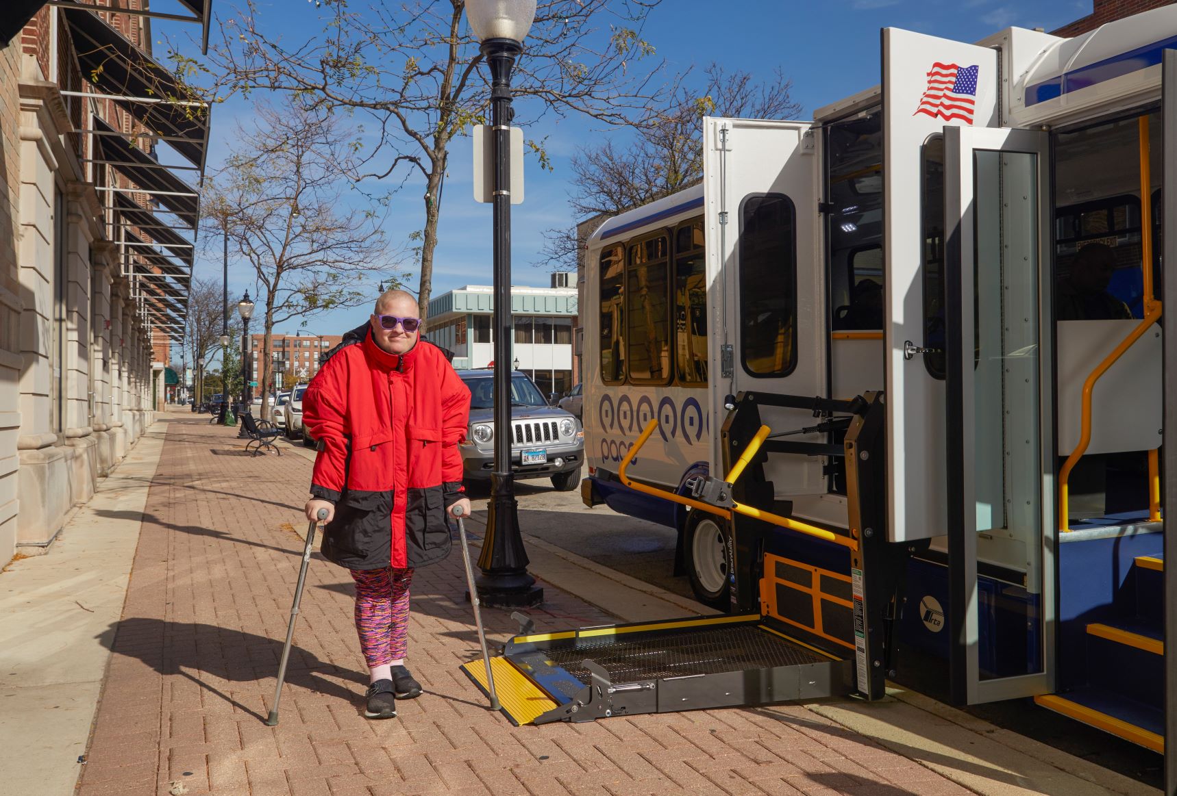 Woman using canes boards paratransit vehicle