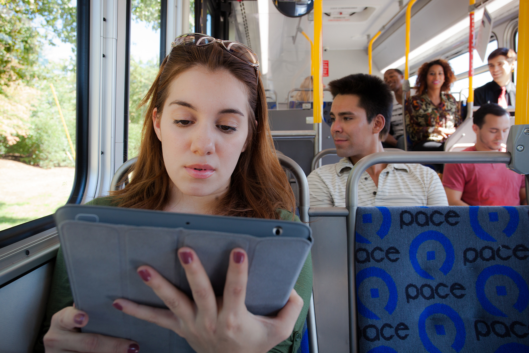 female on tablet on bus