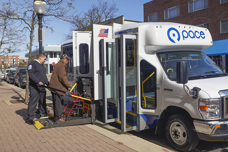 Image of man with walker boarding paratransit vehicle