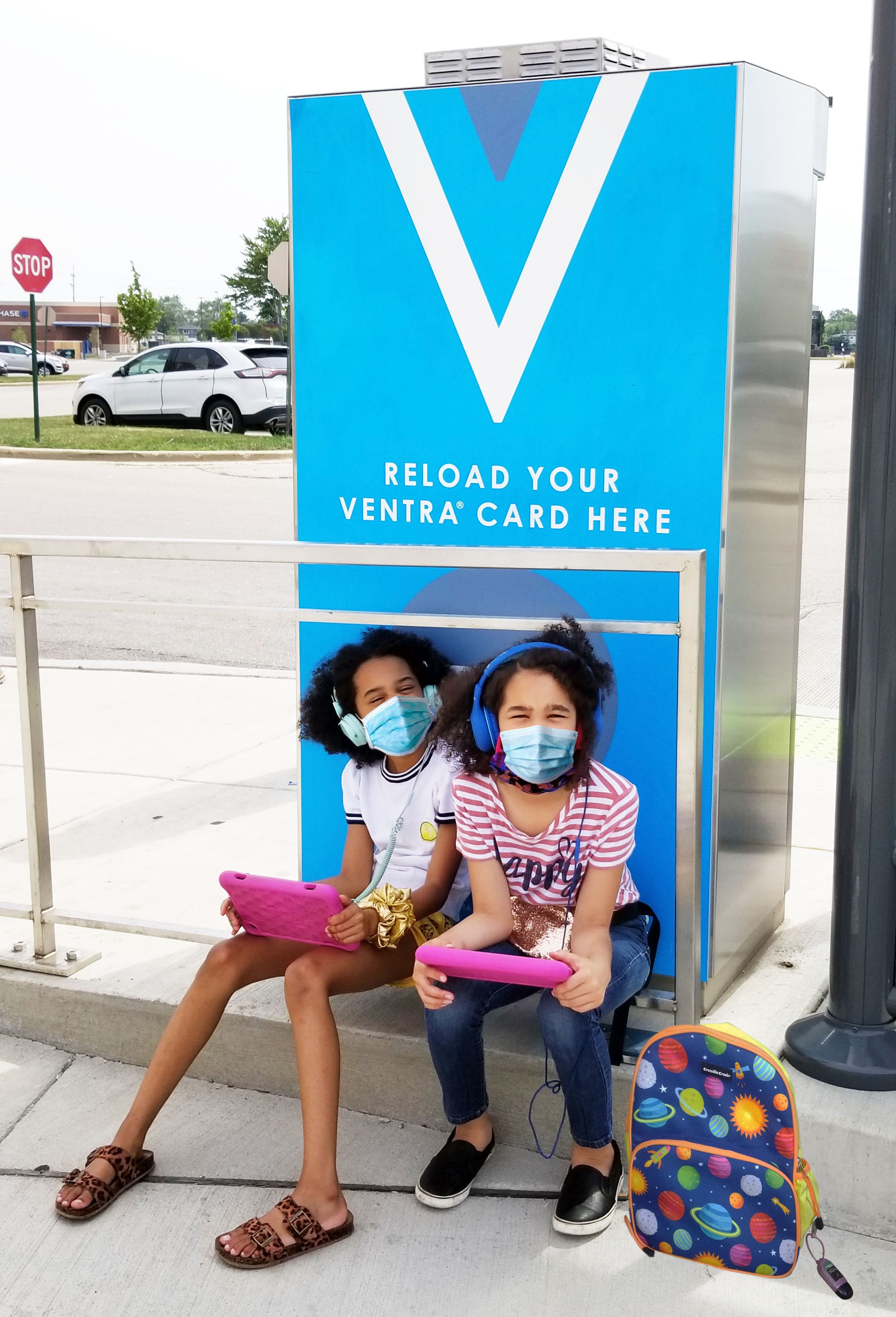 masked students sitting at Ventra vending machine