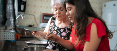 Grandmother and granddaughter cooking