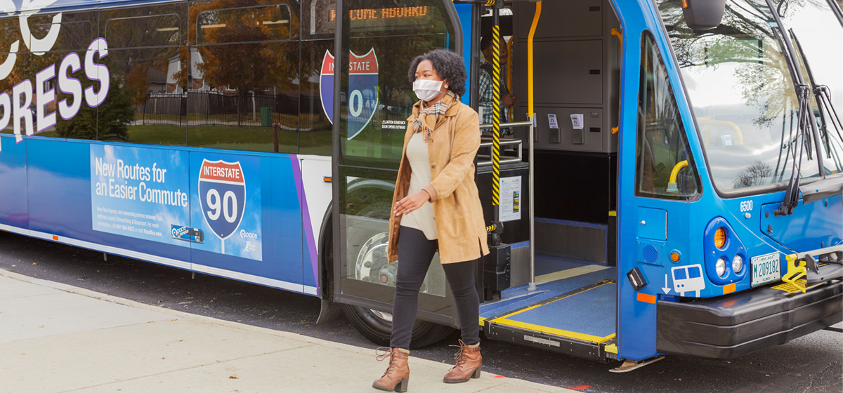 Rider leaving bus with mask