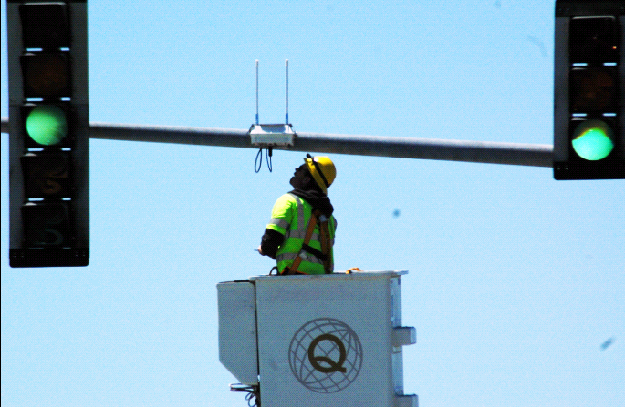 Image showing a worker is installing Transit Signal Priority System