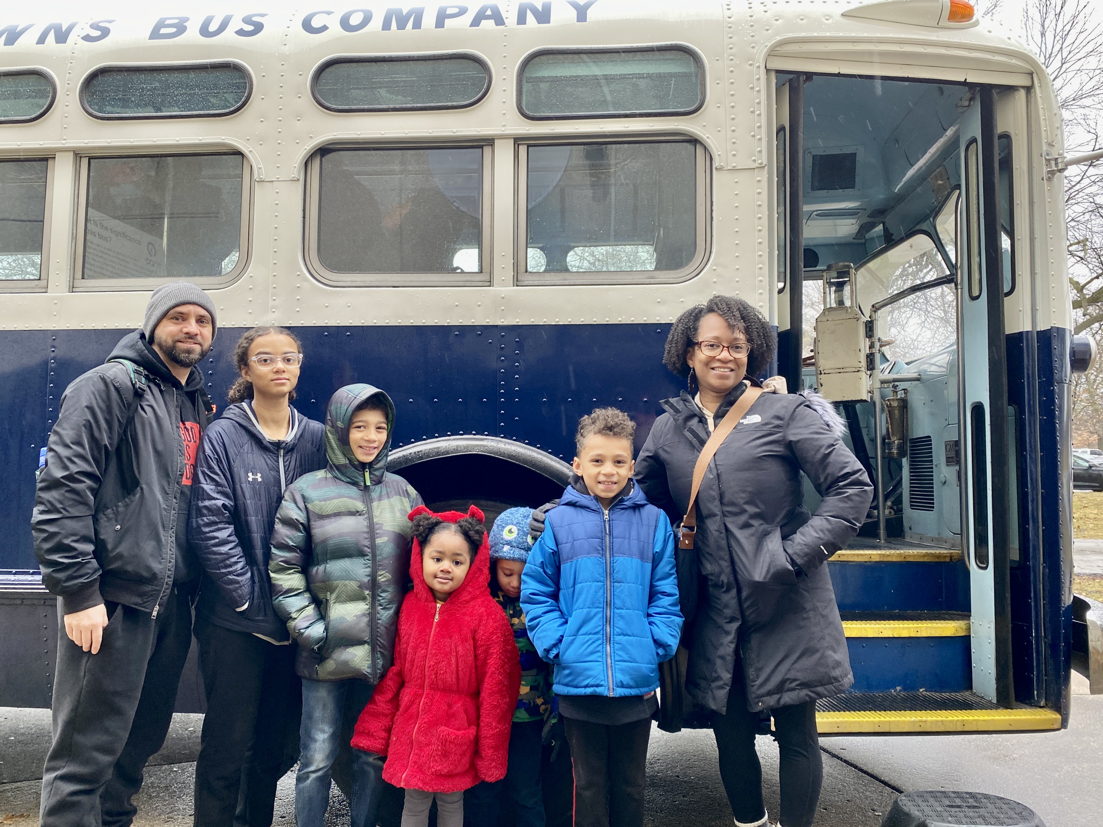 A group of museum visitors outside Pace's vintage bus