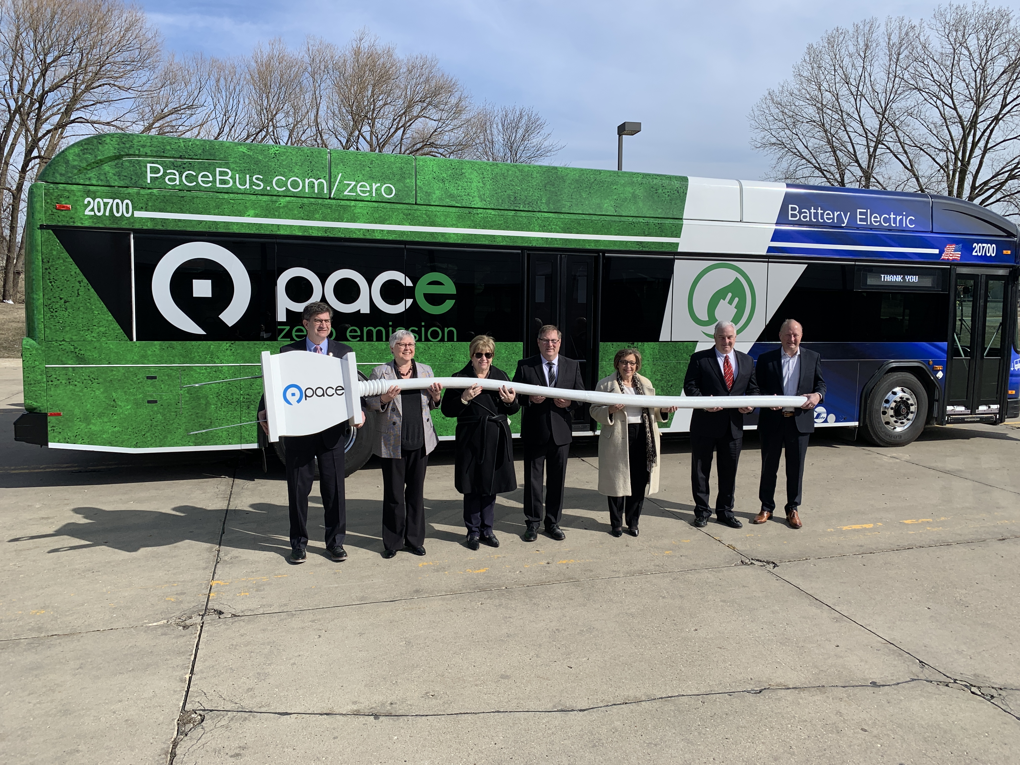 Photo of (L-R) Congressman Brad Schneider; Pace Director Linda Soto; Waukegan Mayor Ann Taylor, Pace Chairman Rick Kwasneski; Pace Executive Director Melinda Metzger; Pace Director Chris Canning; and Lake County Partners President Kevin Considine in front of a Pace electric bus
