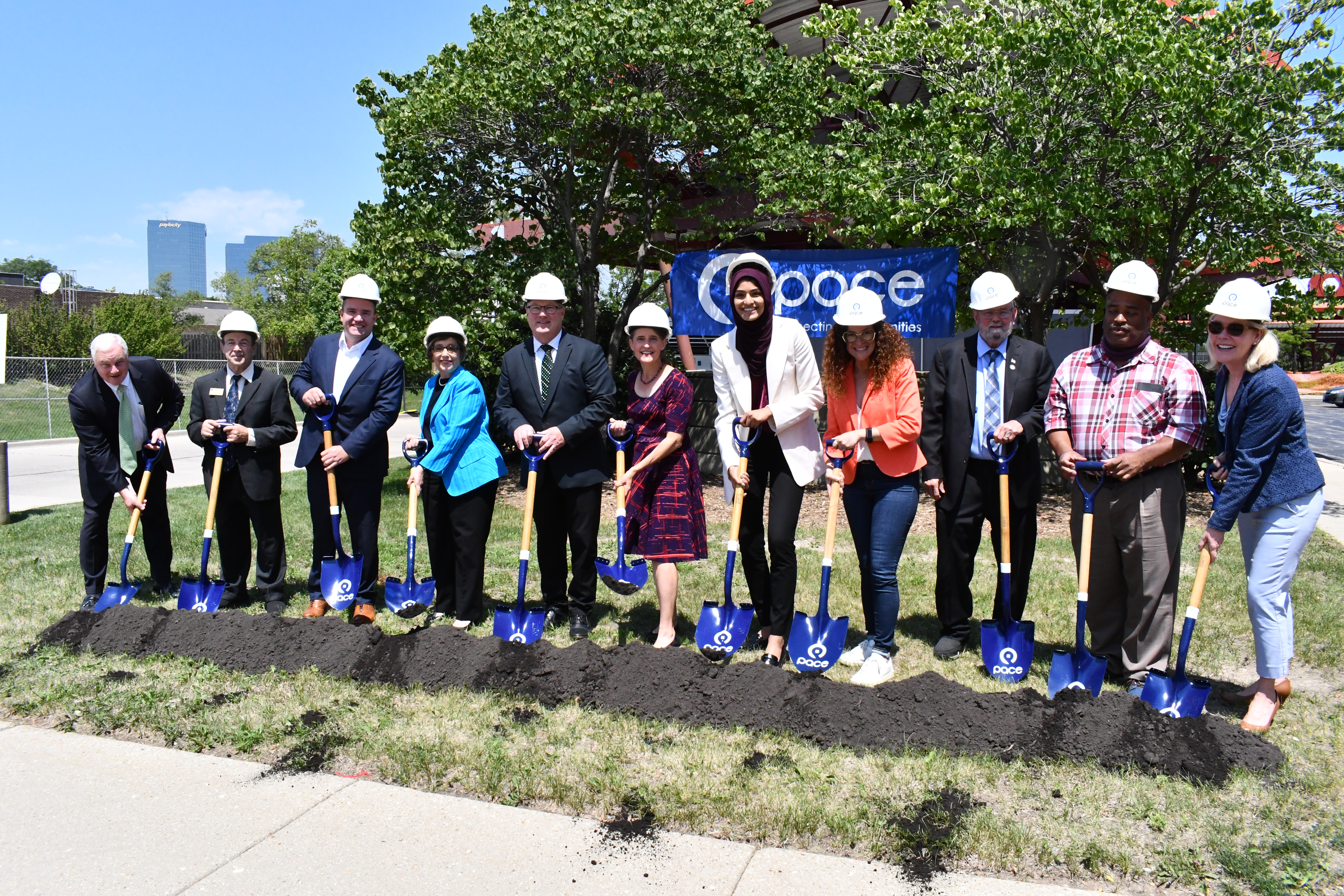 Image of officials with shovels and hardhats breaking ground at Pace's Northwest Transportation Center. 