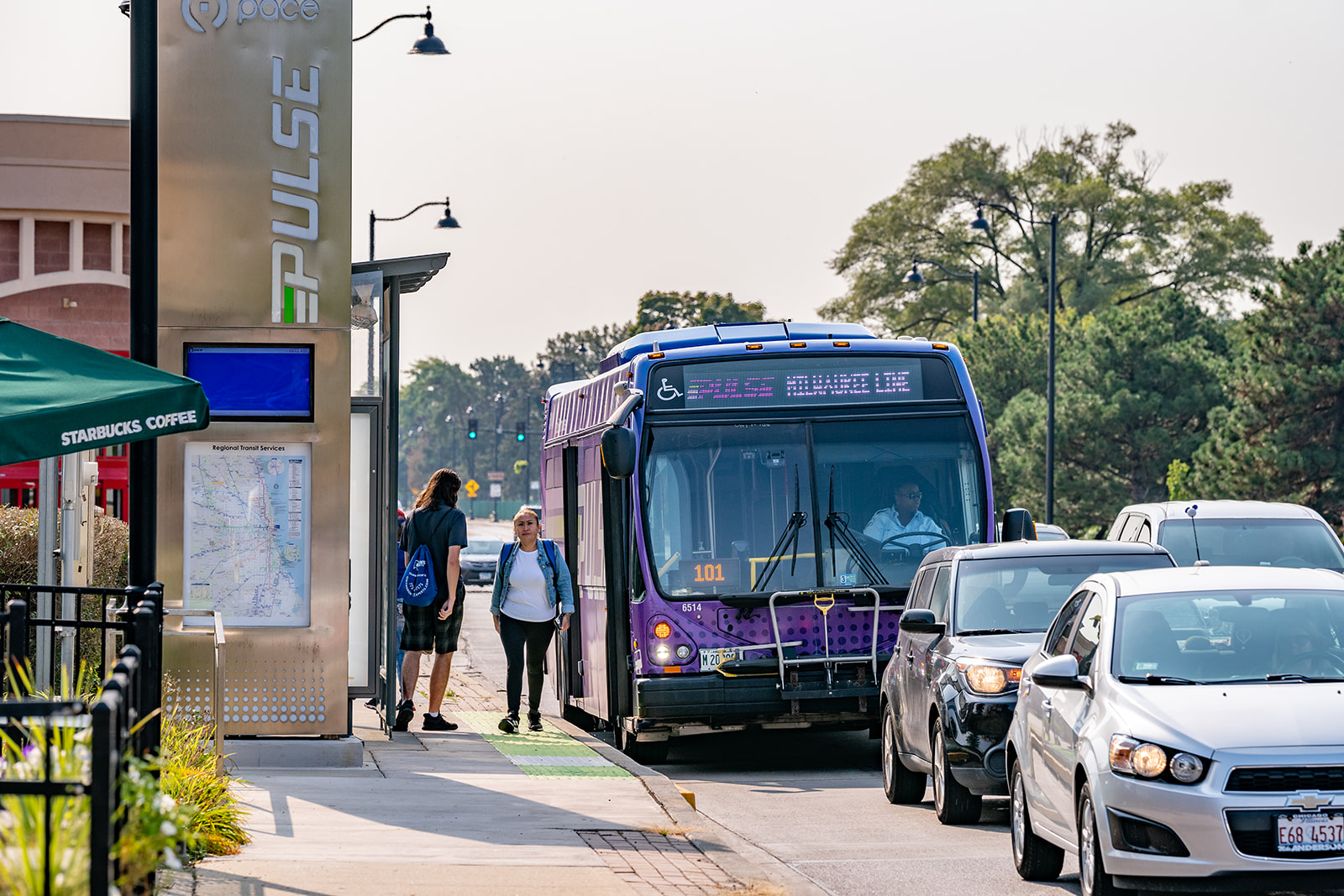 Image of Pulse Bus with riders at station