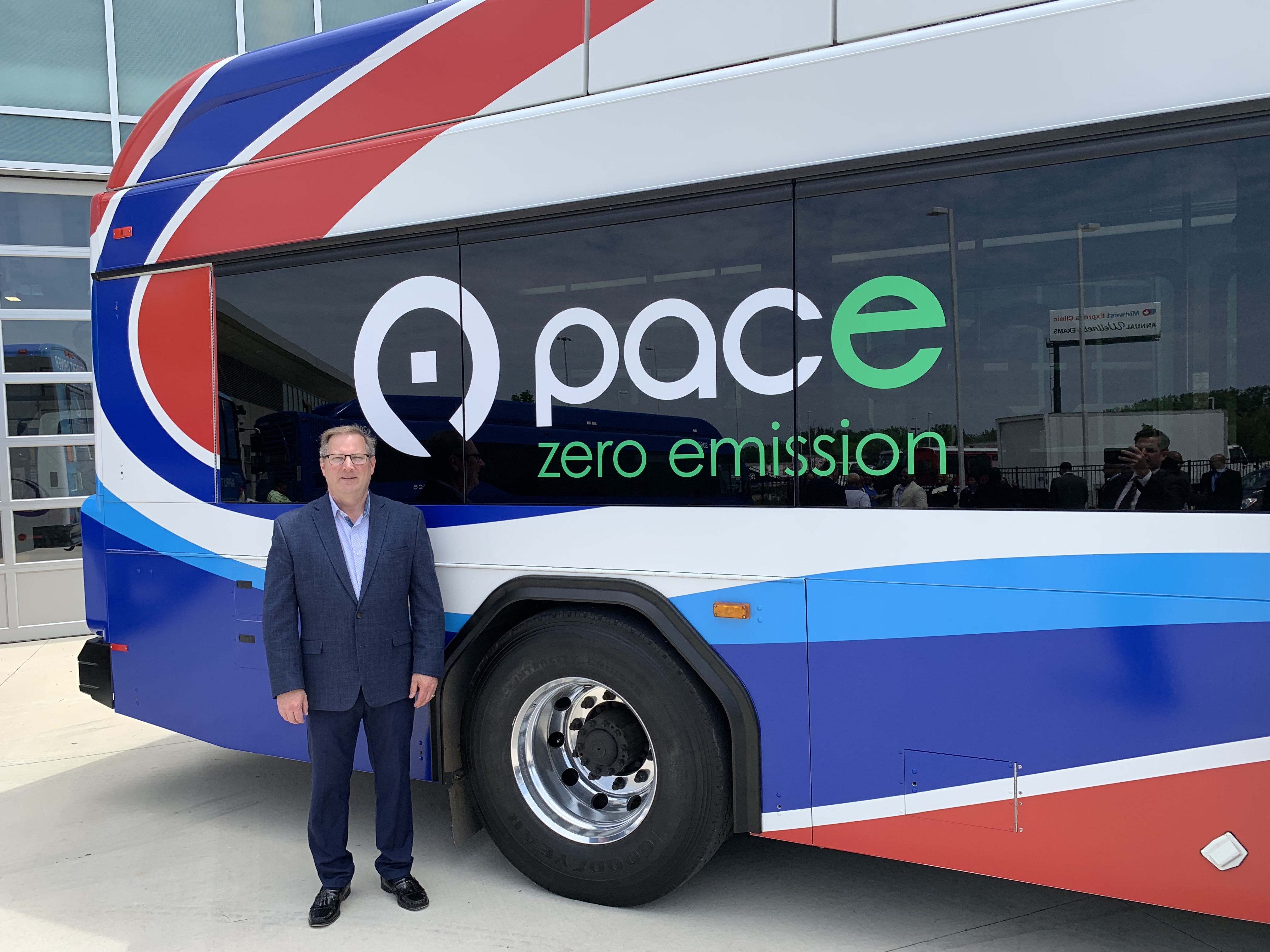 Photo of Pace Chairman Rick Kwasneski in front of a Pace Electric bus.