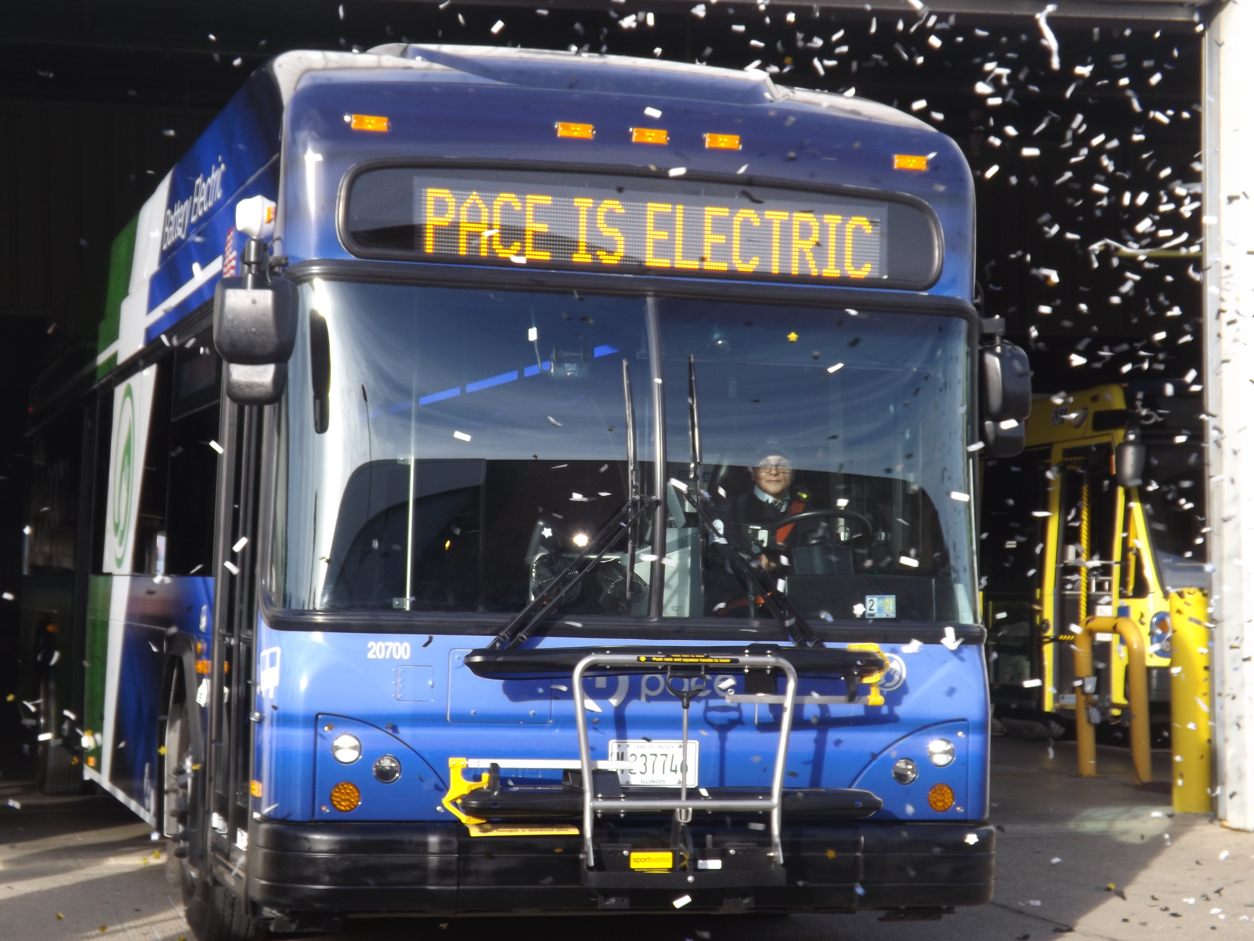 bus sprayed with confetti with "Pace is electric" on its headsign