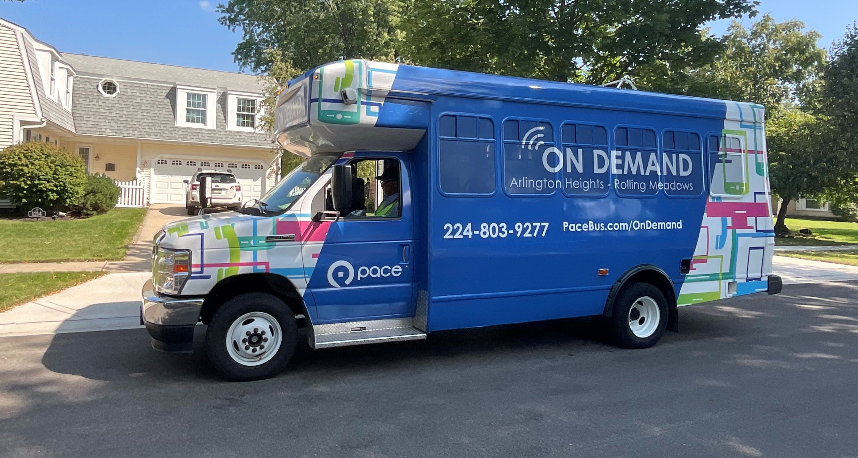 An On Demand vehicle is parked in front of the driveway to a house in Arlington Heights.