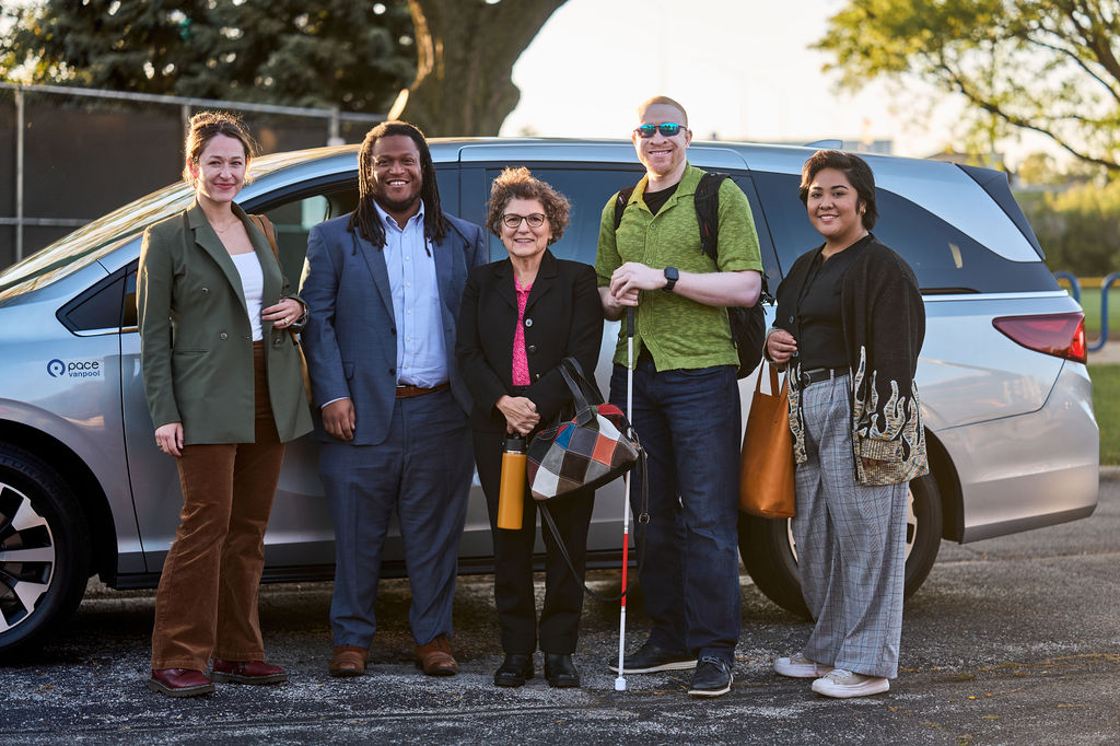 Image shows a group standing in front of Pace van. Grab a few of your friends and commute in comfort too. 