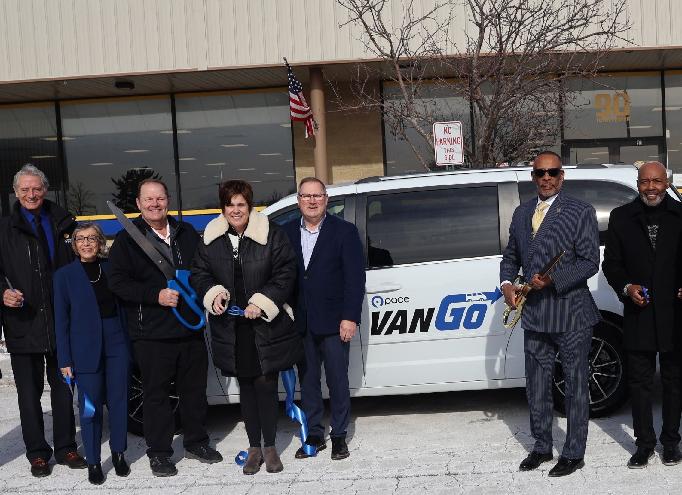 Group of elected and Pace officials cutting ribbon for new VanGo service in University Park.