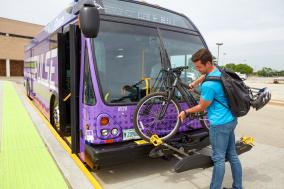man loading bicycle onto Pulse bus