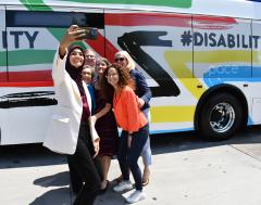 Image of Pace Chairman Kwasneski, Exec. Director Melinda Metzger and and other dignitaries taking a selfie on the side of a Pace Bus