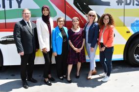 Image of Pace Chairman Kwasneski, Exec. Director Melinda Metzger and and other dignttaries on the side of a Pace Bus