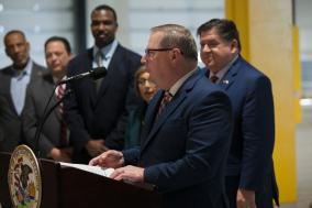 Photo of Pace Chairman Rick Kwasneski speaking at podium during an event in Markham