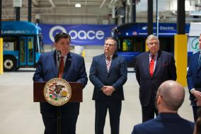 Photo of Illinois Governor JB Pritzker speaking at podium during an event in Markham