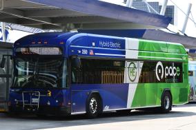 Hybrid-electric bus standing at station
